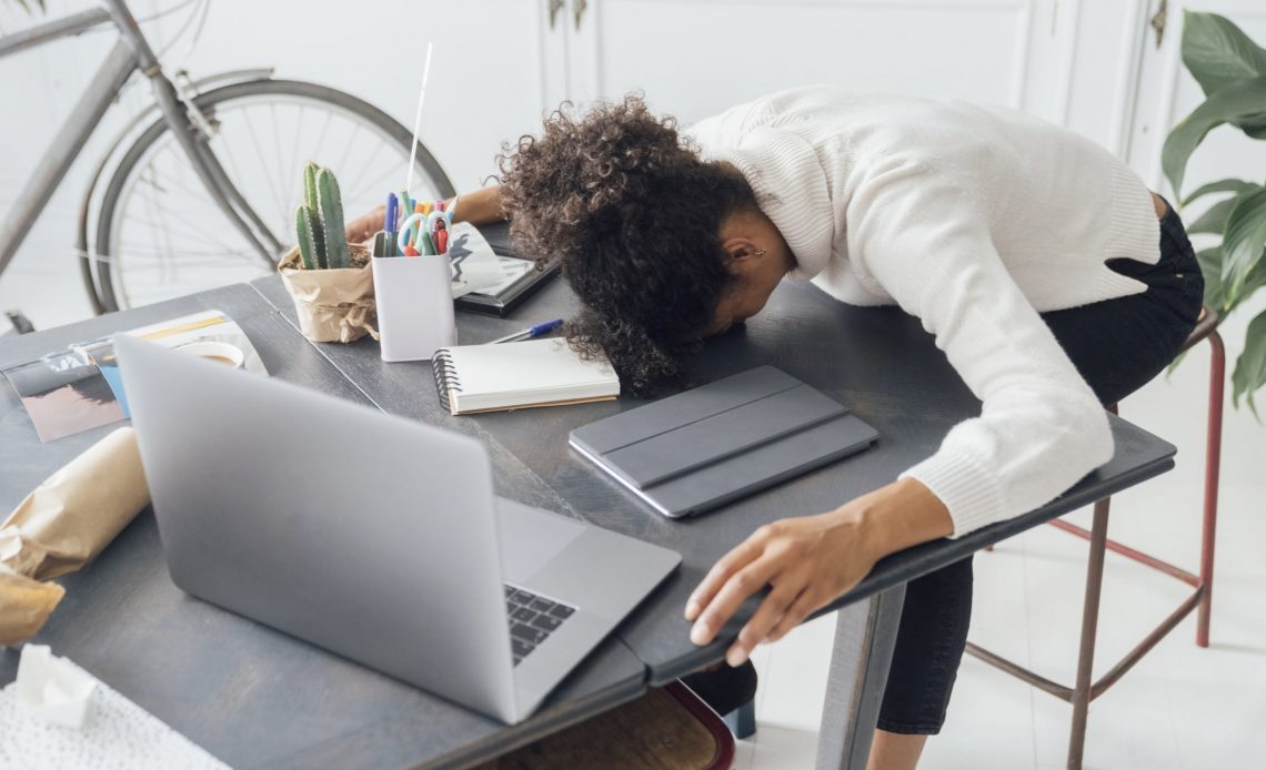 Burnout - Tired freelancer sleeping on her deak