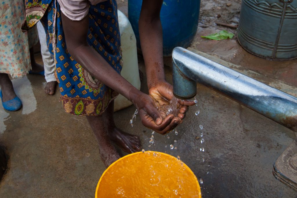 A girl washing her hands at a borehole in southern Malawi.